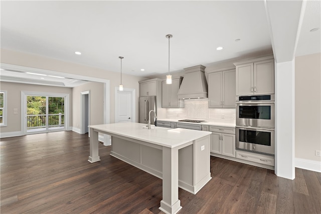 kitchen with custom range hood, gray cabinetry, dark hardwood / wood-style flooring, pendant lighting, and stainless steel appliances