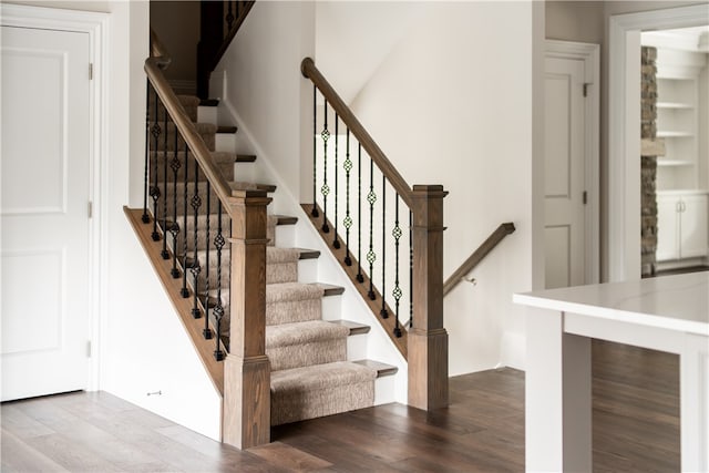 staircase with hardwood / wood-style flooring