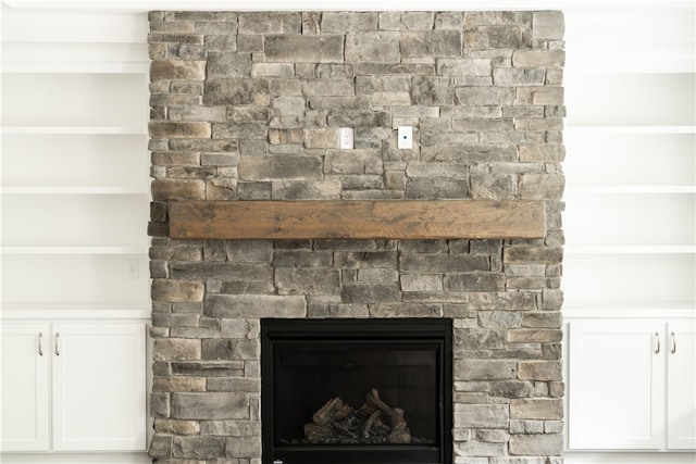 interior details with a fireplace and crown molding