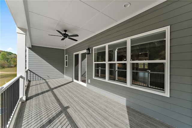 wooden terrace featuring ceiling fan