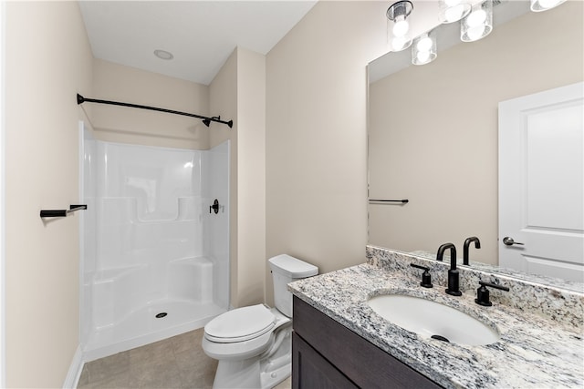 bathroom featuring walk in shower, tile patterned flooring, vanity, and toilet