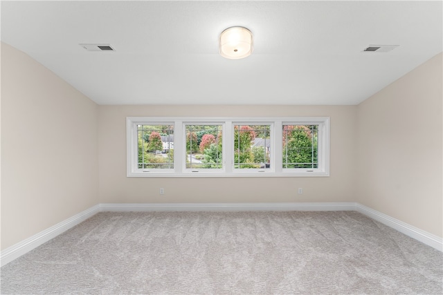 unfurnished room with light carpet