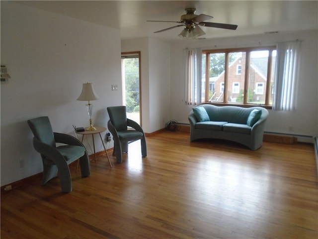 living area featuring ceiling fan and hardwood / wood-style floors