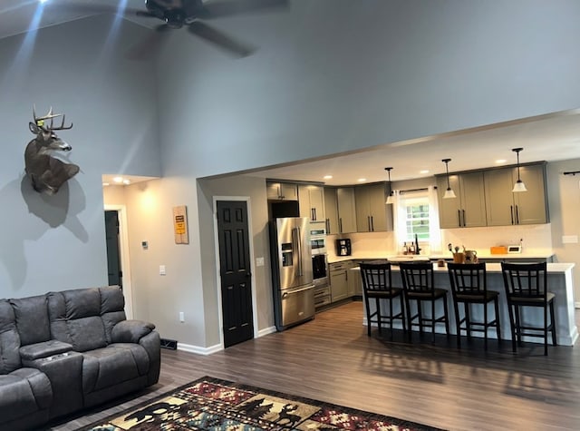 living room with ceiling fan and dark wood-type flooring