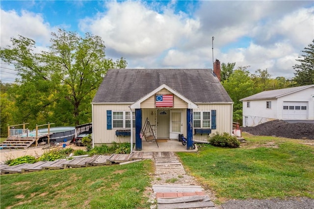 265 Johnston Rd, Bentleyville, PA 15314 - bungalow with a chimney, a front lawn, a shingled roof, and covered porch