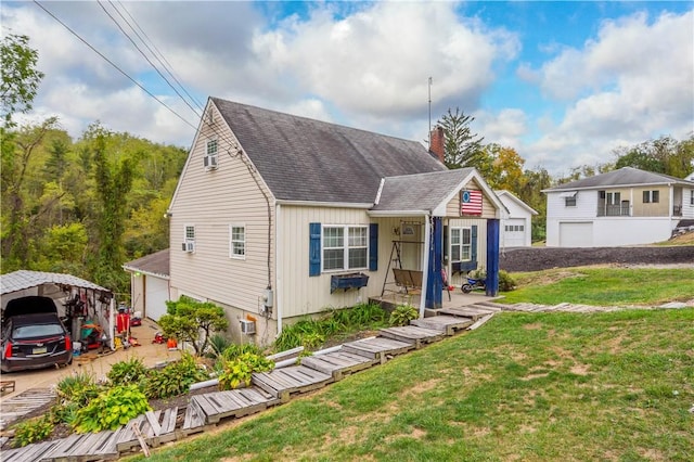 265 Johnston Rd, Bentleyville, PA 15314 - view of front of house with a detached carport, a front lawn, roof with shingles, and a chimney
