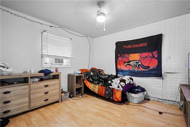 265 Johnston Rd, Bentleyville, PA 15314 - bedroom with light wood-style flooring, brick wall, and a ceiling fan