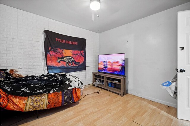 265 Johnston Rd, Bentleyville, PA 15314 - bedroom with wood finished floors, brick wall, baseboards, and ceiling fan