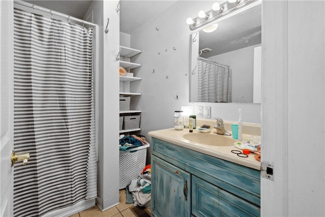 bathroom with a shower with shower curtain, tile patterned floors, and vanity