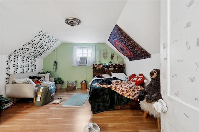 bedroom featuring lofted ceiling and hardwood / wood-style floors