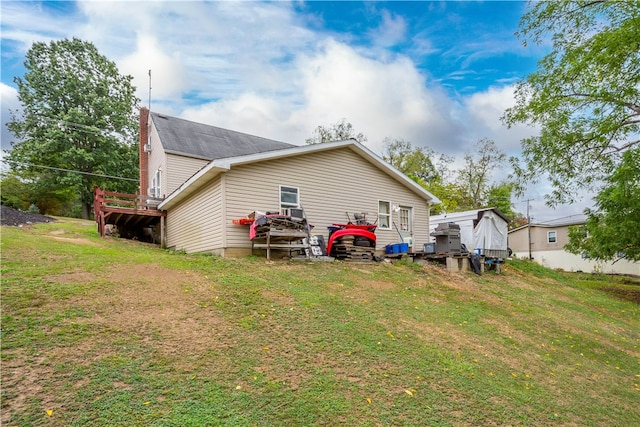 rear view of house featuring a lawn