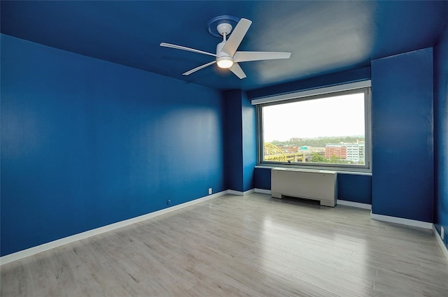 unfurnished room featuring light hardwood / wood-style floors and ceiling fan