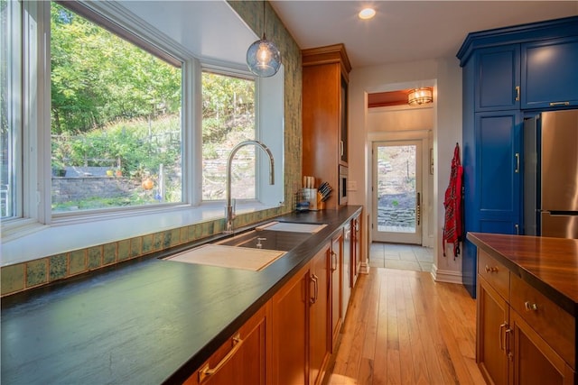 1487 Beaver Rd, Sewickley, PA 15143 - kitchen with dark countertops, freestanding refrigerator, a sink, and plenty of natural light