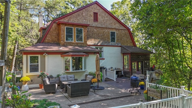 back of property with an outdoor hangout area and a patio