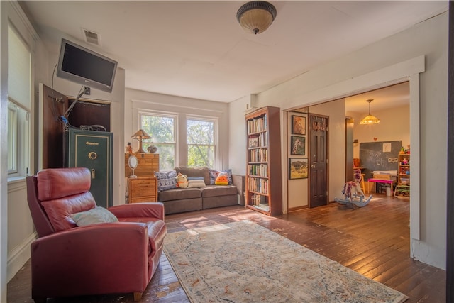 sitting room featuring dark wood-type flooring