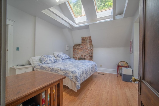 1487 Beaver Rd, Sewickley, PA 15143 - bedroom with baseboards, vaulted ceiling with skylight, and light wood-style flooring