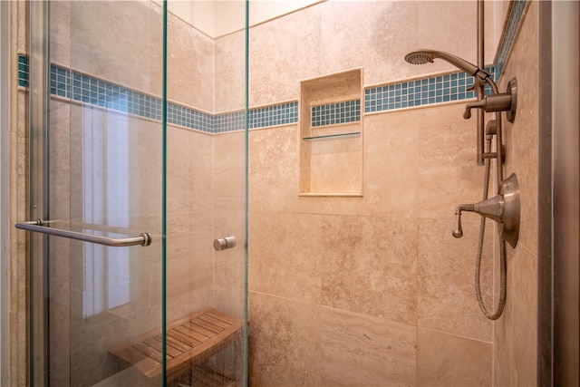 bathroom featuring a shower with shower door