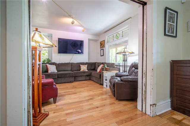 living room with track lighting and light hardwood / wood-style floors