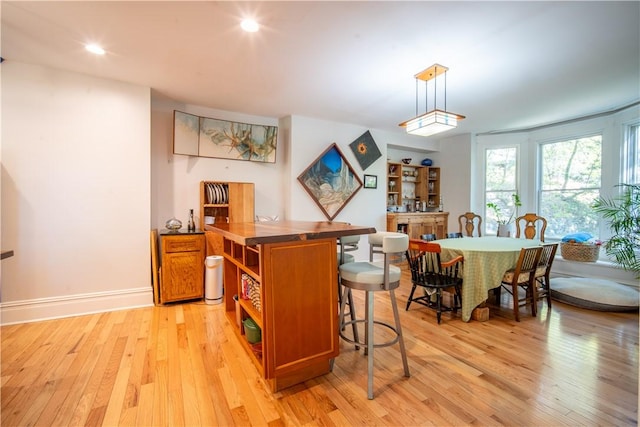 1487 Beaver Rd, Sewickley, PA 15143 - interior space with brown cabinets, recessed lighting, open shelves, light wood-type flooring, and a breakfast bar area