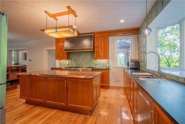 1487 Beaver Rd, Sewickley, PA 15143 - kitchen featuring a center island, ventilation hood, a sink, light wood-style floors, and brown cabinets