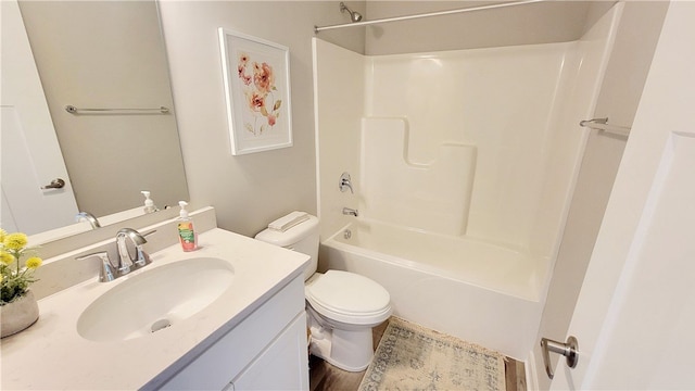 full bathroom featuring toilet, vanity, and washtub / shower combination