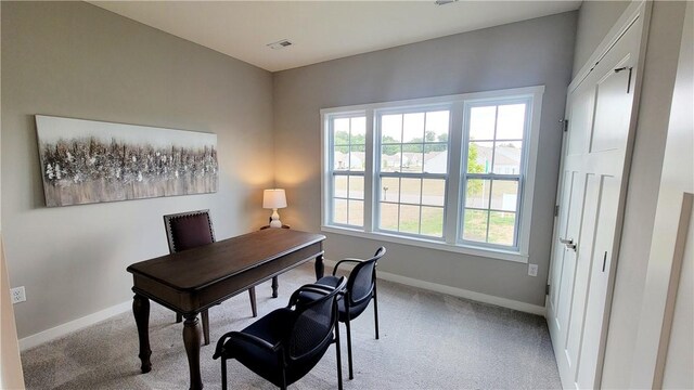 office space with baseboards and light colored carpet