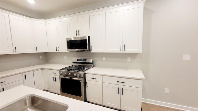 kitchen featuring appliances with stainless steel finishes and white cabinetry