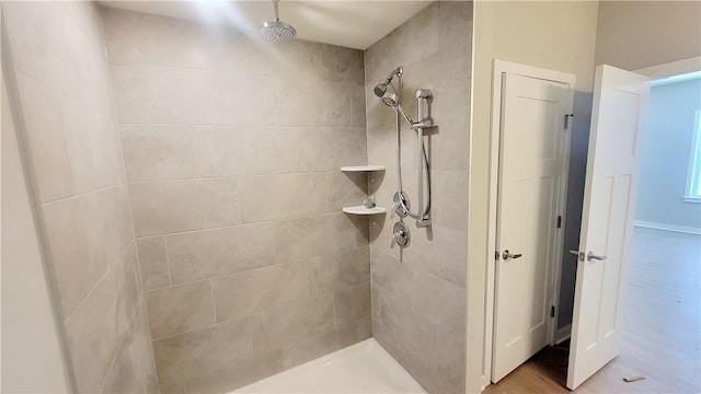 bathroom with a tile shower