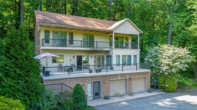 view of front of home with a balcony and a garage