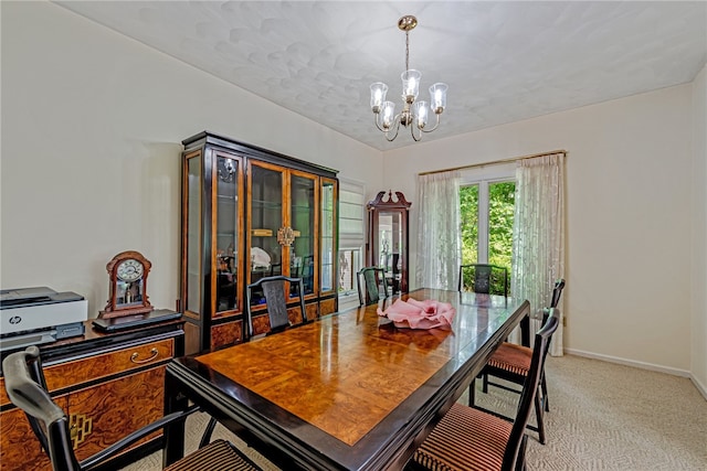 carpeted dining area with an inviting chandelier