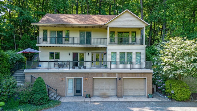 view of front of house featuring a balcony and a garage