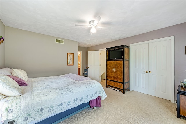 carpeted bedroom with a closet and ceiling fan