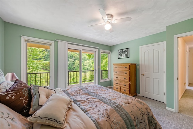 carpeted bedroom with ceiling fan and access to exterior