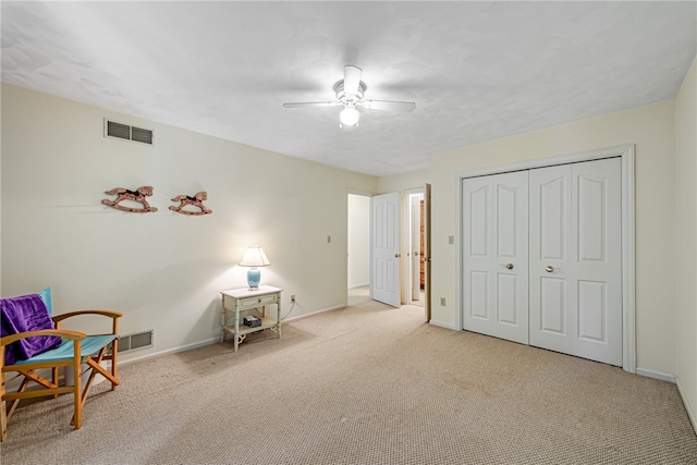 living area with light carpet and ceiling fan