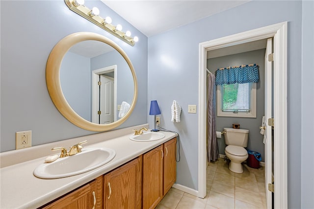 bathroom featuring tile patterned floors, vanity, and toilet