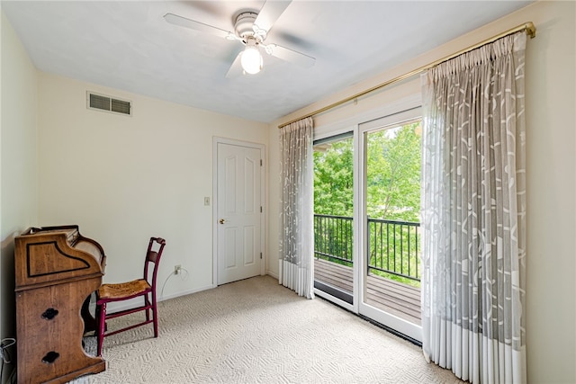 interior space featuring ceiling fan and light carpet