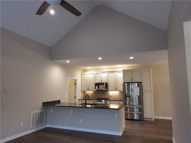 kitchen featuring kitchen peninsula, high vaulted ceiling, appliances with stainless steel finishes, dark hardwood / wood-style flooring, and ceiling fan