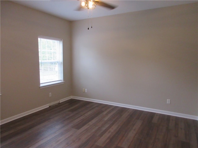 empty room featuring dark wood-type flooring and ceiling fan