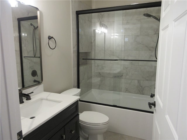 full bathroom featuring shower / bath combination with glass door, vanity, and toilet