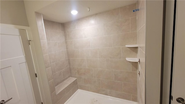 bathroom with tiled shower