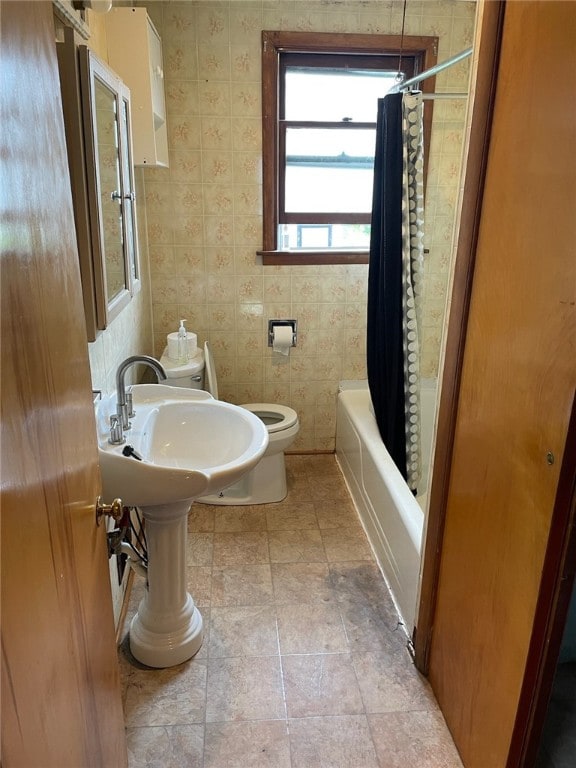 bathroom with shower / tub combo and toilet