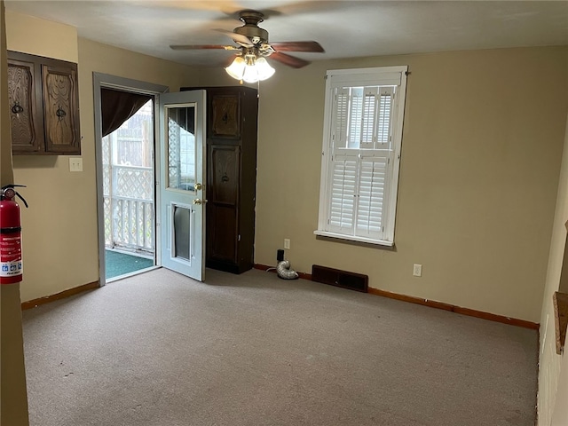 empty room with light carpet and ceiling fan