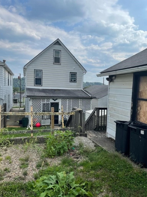 rear view of house featuring a deck