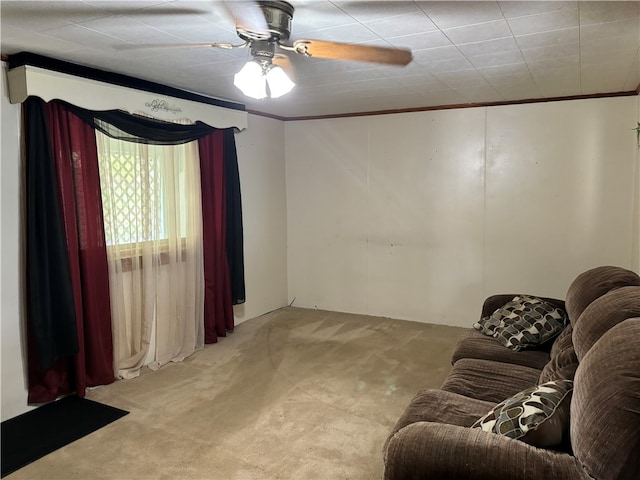 living room featuring ceiling fan, light colored carpet, and crown molding