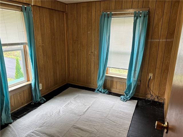 empty room featuring light hardwood / wood-style flooring and wood walls