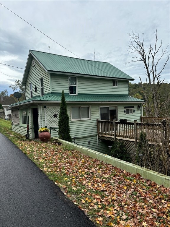 rear view of house featuring a deck