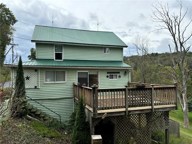 rear view of property with a wooden deck