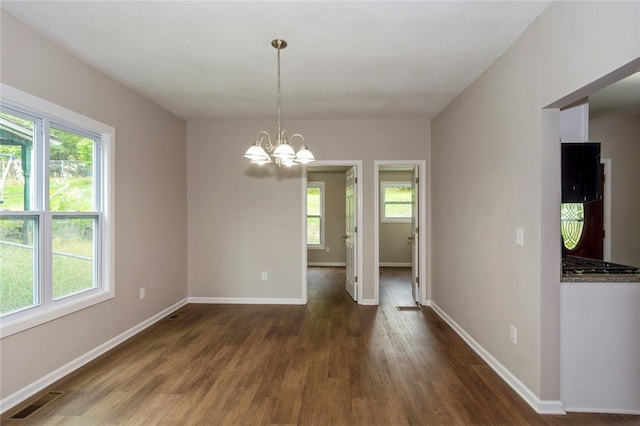 interior space with an inviting chandelier and dark hardwood / wood-style flooring