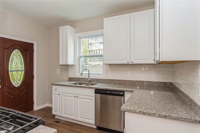 kitchen with light stone counters, dark hardwood / wood-style floors, white cabinetry, and stainless steel dishwasher