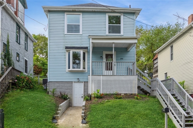 view of property featuring a wooden deck and a front yard